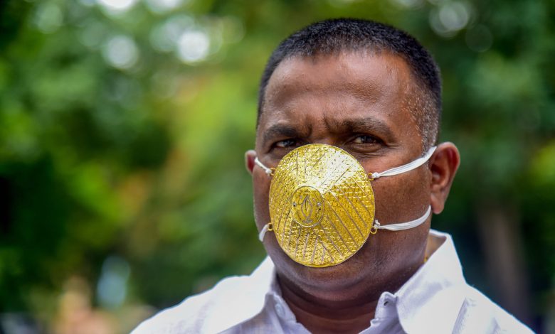 Indian man wears gold face mask to ward off coronavirus