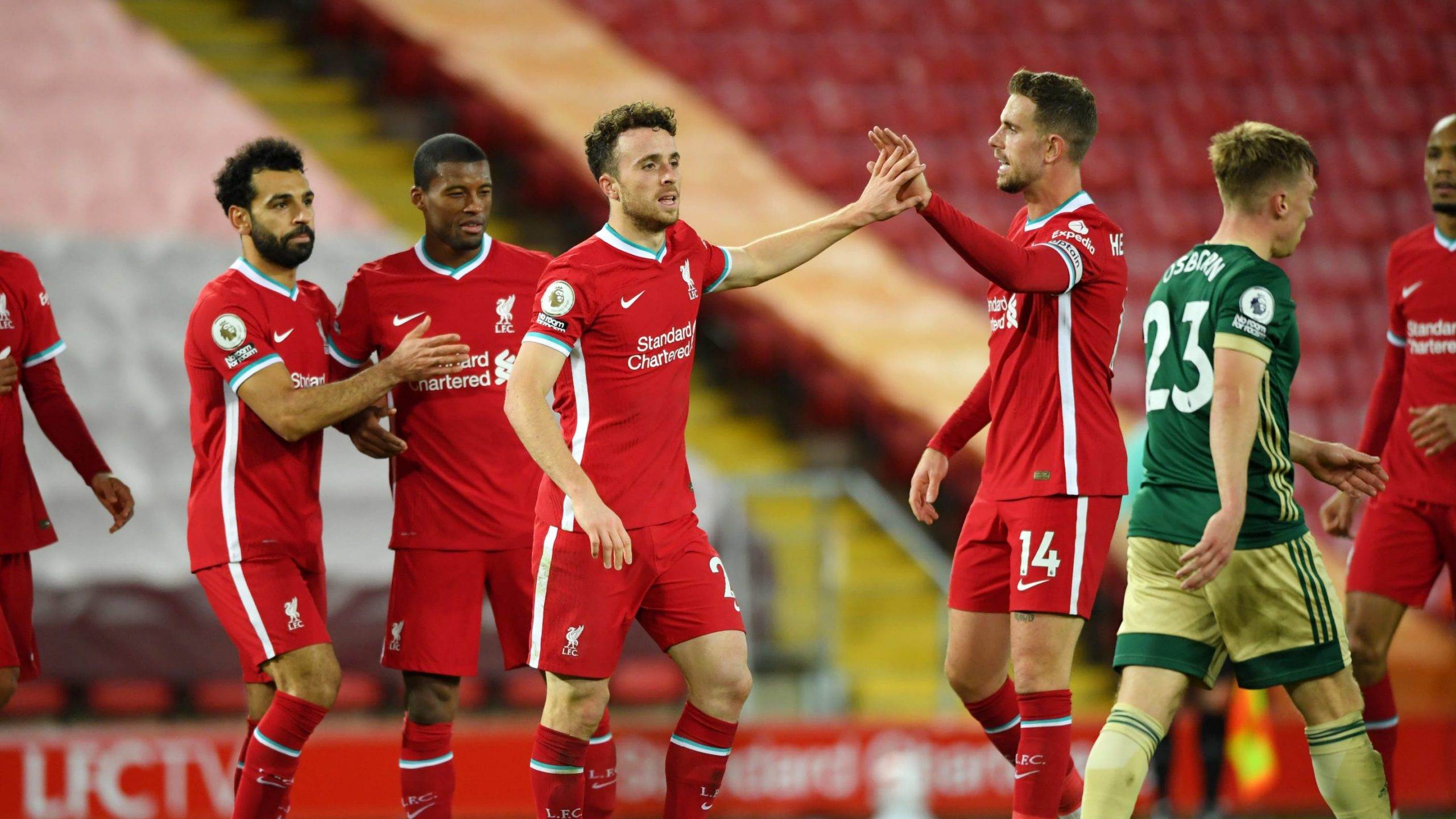  Liverpool's Jordan Henderson celebrates scoring his team's first goal with teammates Mohamed Salah, Sadio Mane and Roberto Firmino during the Premier League match between Liverpool and Sheffield United at Anfield on February 2, 2021.