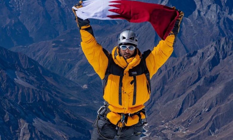 The Qatari flag flies over the summit of Ama Dablam 