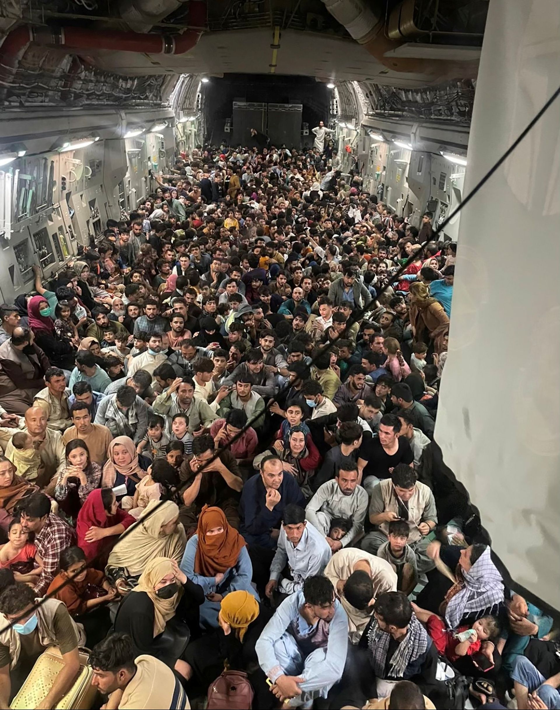 The great escape.. Shocking picture of hundreds of Afghans "crammed" inside military plane