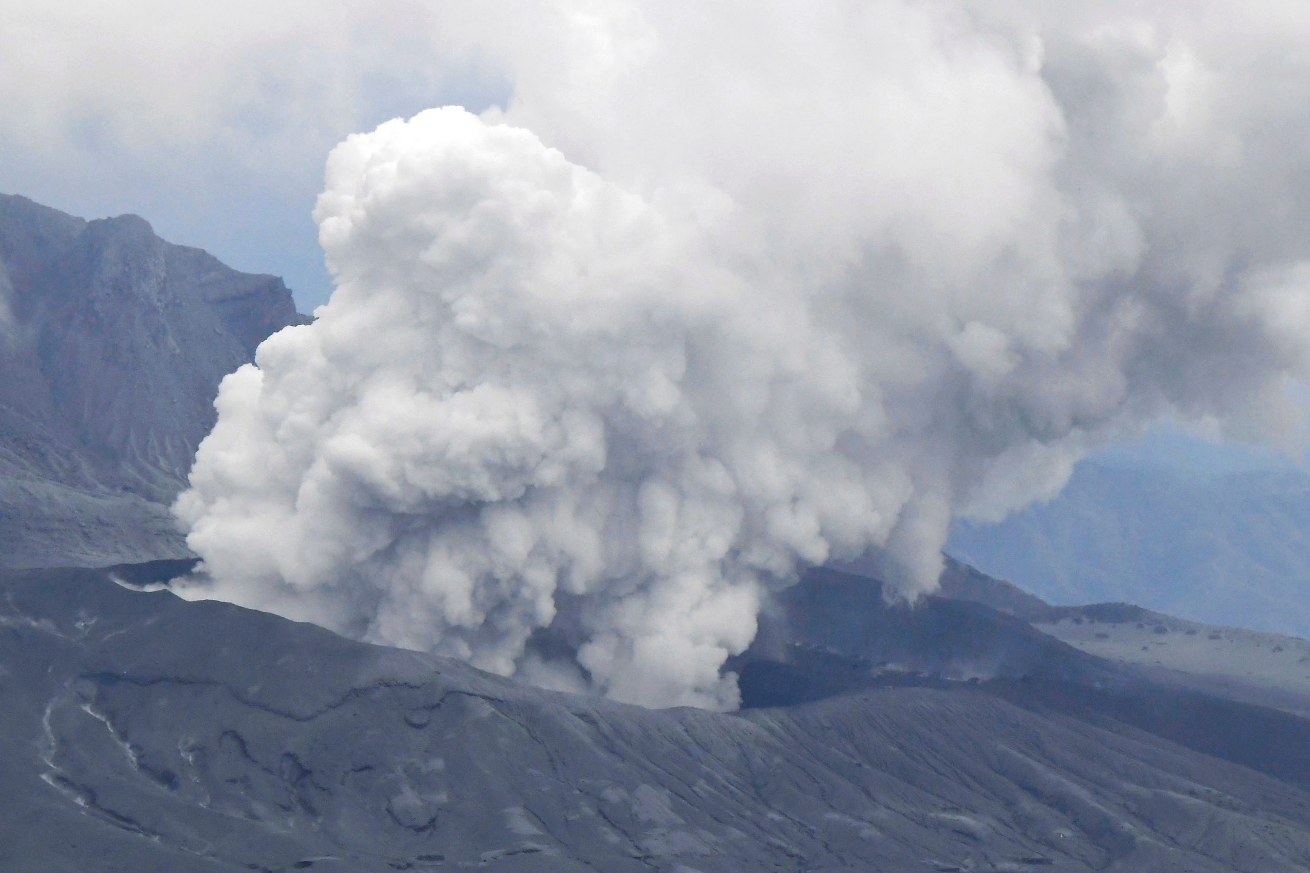 Japanese volcano spews plumes of ash, people warned away